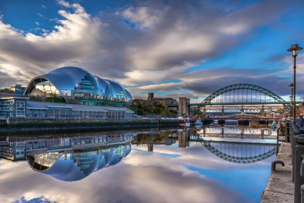 River Tyne in the foreground with the tyne bridge and the Glasshouse International music centre in the background